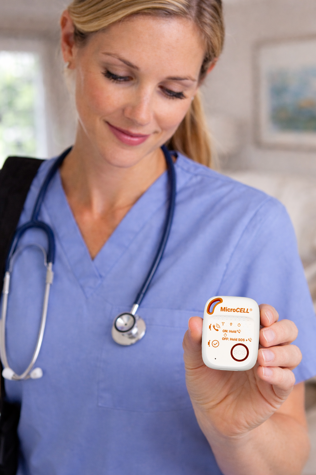 A nurse holding a Grace Industries MicroCELL in one hand, showing how small it is
